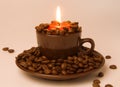 Burning candle and coffee beans Royalty Free Stock Photo