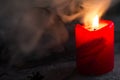 Burning candle, dark, disturbing background, smoke. Halloween concept Royalty Free Stock Photo