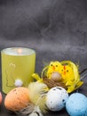 Burning candle, easter colorful eggs and nest Royalty Free Stock Photo