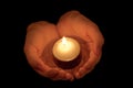 Burning candle in female hands Royalty Free Stock Photo