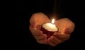 Burning candle in female hands Royalty Free Stock Photo