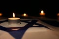 Burning candle on flag of Israel. Holocaust memory day Royalty Free Stock Photo