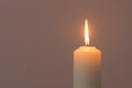 A burning candle flame isolated on black or dark background on table in church for Christmas, funeral and memorial service Royalty Free Stock Photo