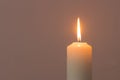 A burning candle flame isolated on black or dark background on table in church for Christmas, funeral and memorial service Royalty Free Stock Photo