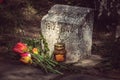 Burning candle and flowers tulips vested at the monument