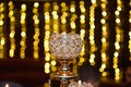 Burning candle in a glass candle holder with bokeh background Royalty Free Stock Photo