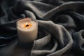 Burning candle in glass with wooden wick, handmade natural wax candle with knitted blanket Royalty Free Stock Photo