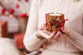 Burning candle in the hands of a girl. Christmas candle. Christmas decor. Woman`s hands holding beautiful candle with fire. Copy Royalty Free Stock Photo