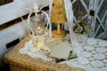 Burning candle, lace, old chest of drawers shabby chic, stack of retro photos of 50-60s, reverse side of photo, flowers, concept