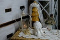 Burning candle, lace, old chest of drawers shabby chic, white angel figurine, wooden mannequin, flowers, concept of family tree,