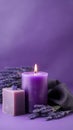 Burning candle with lavender and soap on purple background, minimalism