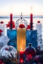 burning candle, moon symbol, amulet and crystal ball lying on a light natural background with the sea in the background