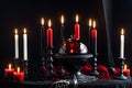 burning candle, moon symbol, amulet lying on a dark natural background. Witchcraft, esoteric spiritual ritual. holiday