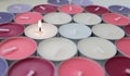 Burning candle among multicolored unlit candles Royalty Free Stock Photo