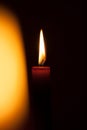 A burning candle at night. Symbol of life, love and light, protection and warmth. Candle flame glowing on a dark background. Royalty Free Stock Photo