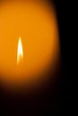 A burning candle at night. Symbol of life, love and light, protection and warmth. Candle flame glowing on a dark background. Royalty Free Stock Photo