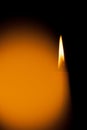 A burning candle at night. Symbol of life, love and light, protection and warmth. Candle flame glowing on a dark background. Royalty Free Stock Photo