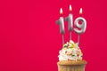 Burning candle number 119 - Birthday card with cupcake Royalty Free Stock Photo