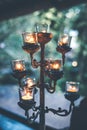 Burning candle on old brass candlestick over low contrast green background. Royalty Free Stock Photo