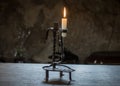 The burning candle in an old candlestick Royalty Free Stock Photo