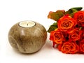 Burning candle and orange roses isolated on white background. Royalty Free Stock Photo