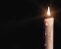 Burning candle over black Royalty Free Stock Photo