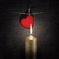 Burning candle and red paper heart on a rope Royalty Free Stock Photo