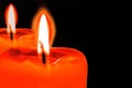 Burning candle with reflection or pair of candles with flame on black backgroung with . macro of religion spirituality,