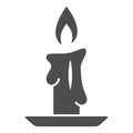 Burning candle solid icon, New Year concept, candle sign on white background, Burning candle in candlestick icon in