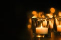 Burning candle on table in darkness. Funeral symbol Royalty Free Stock Photo