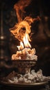 a burning candle on top of a pile of paper