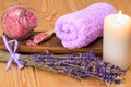 burning candle, towel and sea salt with lavender close-up objects for spa Royalty Free Stock Photo