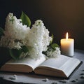 Funeral candle, white lilac flowers and open book on dark background. Sympathy card. Royalty Free Stock Photo