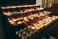 Burning candles on altar close-up in church, lighting candle, mourning victims in terrorism attacks and revolutions, sadness