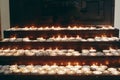 Burning candles on altar close-up in church, lighting candle, mourning victims in terrorism attacks and revolutions, sadness