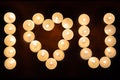 Burning candles arranged in the shape of heart. Inscription I LOVE YOU Royalty Free Stock Photo