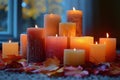 Burning Candles With Autumn Leaves on a Windowsill Royalty Free Stock Photo