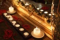 Burning candles and beads lie near mirror Royalty Free Stock Photo