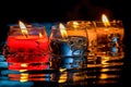 Burning candles on a black background with reflection and water drops. Generative AI Royalty Free Stock Photo