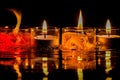 Burning candles on a black background with reflection and water drops. Generative AI Royalty Free Stock Photo