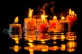 Burning candles on a black background with reflection and water drops. Generative AI Royalty Free Stock Photo