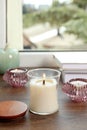 Burning candles with books on wooden window sill Royalty Free Stock Photo
