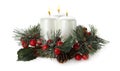 Burning candles with Christmas decor isolated on white Royalty Free Stock Photo