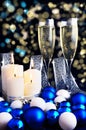 Burning candles, Christmas ornaments and champagne glasses Royalty Free Stock Photo