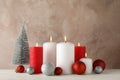 Burning candles, christmas tree and balls against brown background Royalty Free Stock Photo