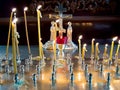 Burning candles before the crucifix in the interior of an Orthodox church Royalty Free Stock Photo