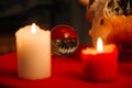 Burning candles and crystal ball. Wicca, esoteric, divination and occult background with vintage magic objects