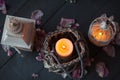 Burning candles in a decorative basket and lantern.