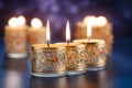 Burning candles in elegant gold candlesticks