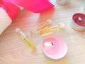 Burning candles with essential spa oil and white towel on wooden table background Royalty Free Stock Photo